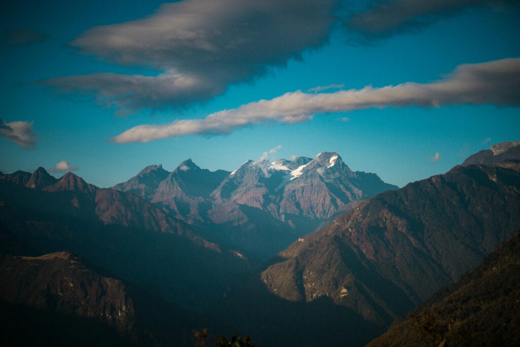 Experience the majestic beauty of Tawang's mountain range with snow-capped peaks and dramatic skies.