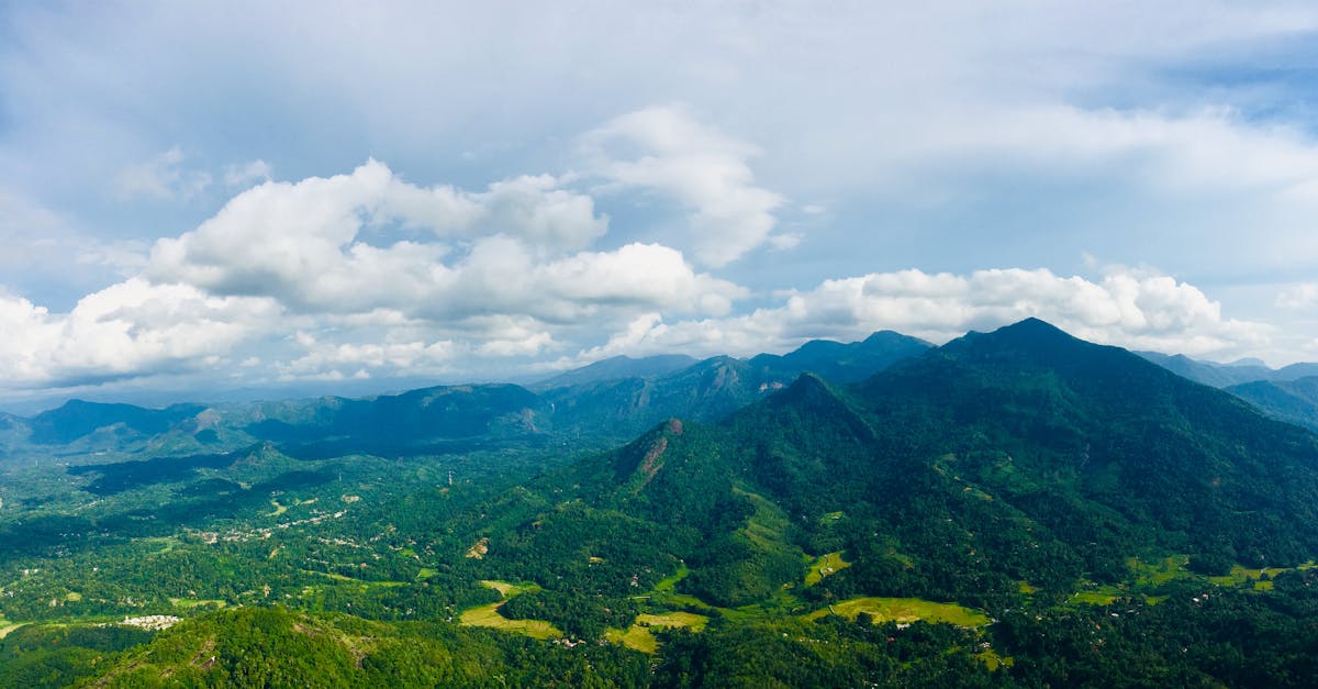 An expansive view of verdant mountains and valleys under a bright sky in Kegalle, Sri Lanka.