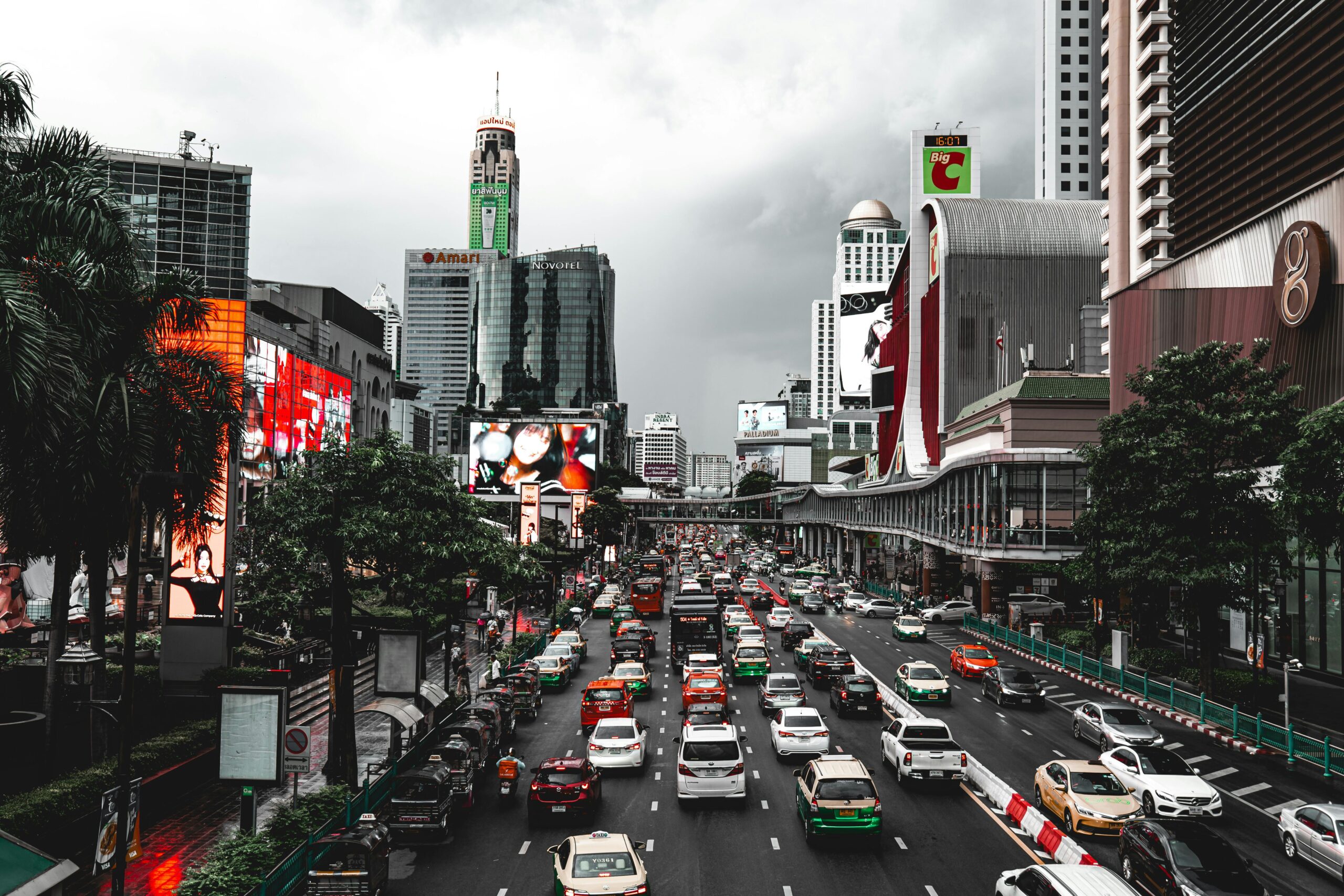 Dynamic view of traffic and skyscrapers in Bangkok, showcasing urban life.