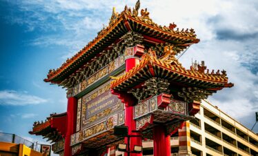 Vibrant Chinatown gate under clear sky in Bangkok, showcasing traditional architecture.